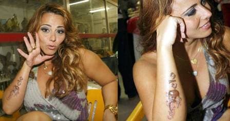 Viviane Araújo apaga tatuagem com nome de Belo do braço