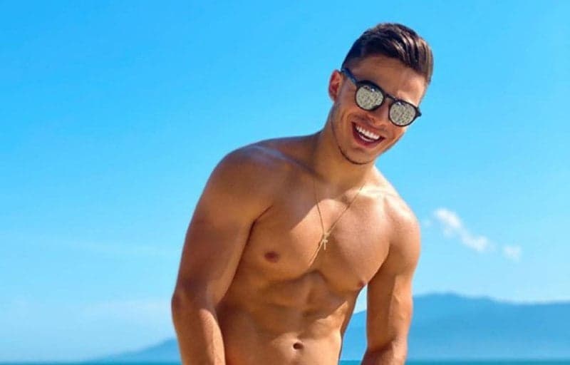 Thomaz Costa surge de pernas abertas usando sunga minúscula e parte íntima fica marcada