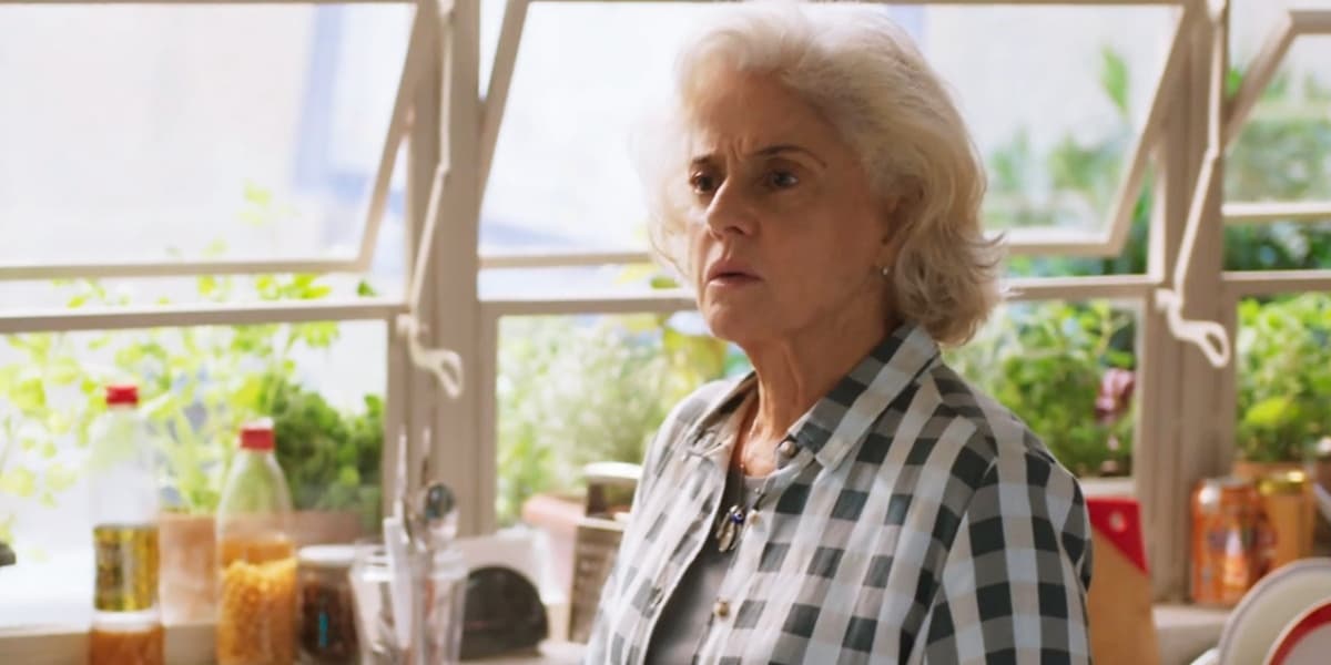 Noca usando camisa xadrez na cozinha em cena da novela Um Lugar ao Sol