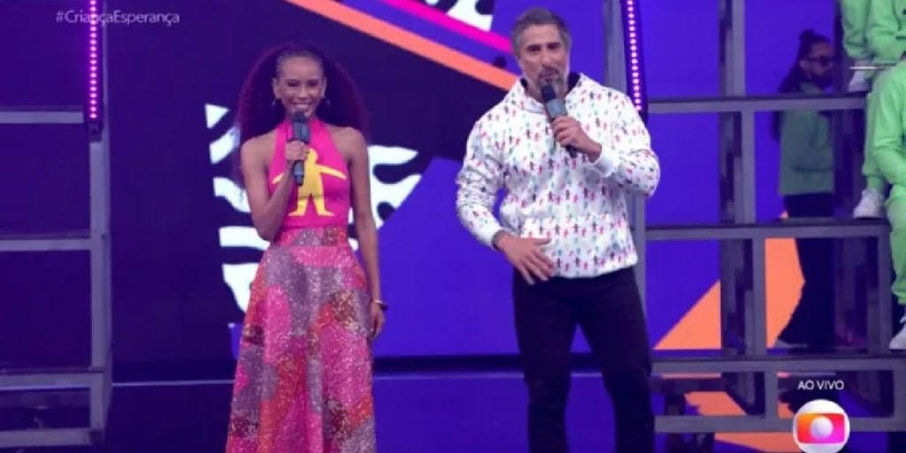 “Só um segundinho”, Marcos Mion dá cortada em Taís Araújo ao vivo e dispara recado: “Eu preciso”