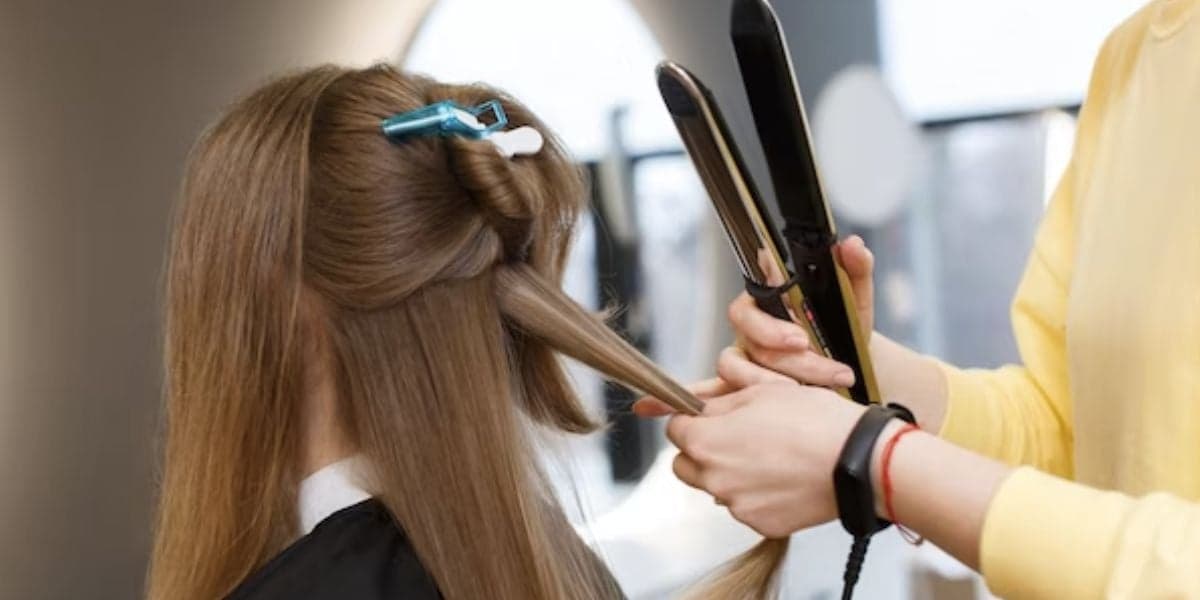 Mulher fazendo alisamento em salão (Foto: Reprodução / Freepik)